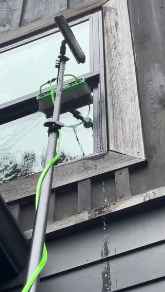 Second story exterior window cleaning at a Drasco Arkansas lakehouse