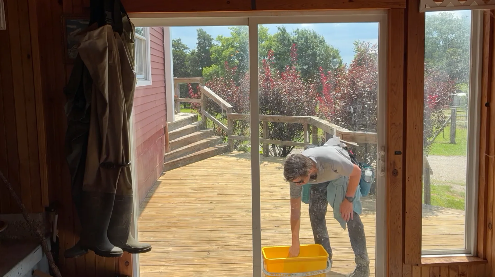 Main sunroom windows before cleaning at a Mountain View Arkansas home, looking out to the deck