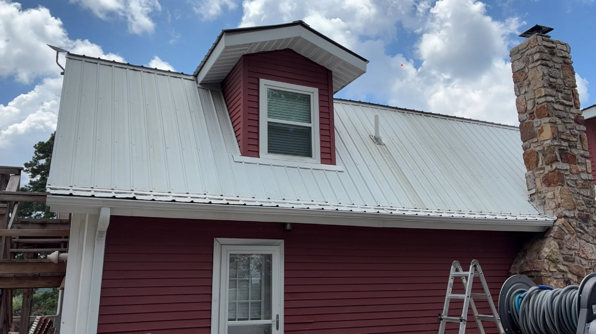 Metal roof and dormer before soft washing on a Mountain View Arkansas home