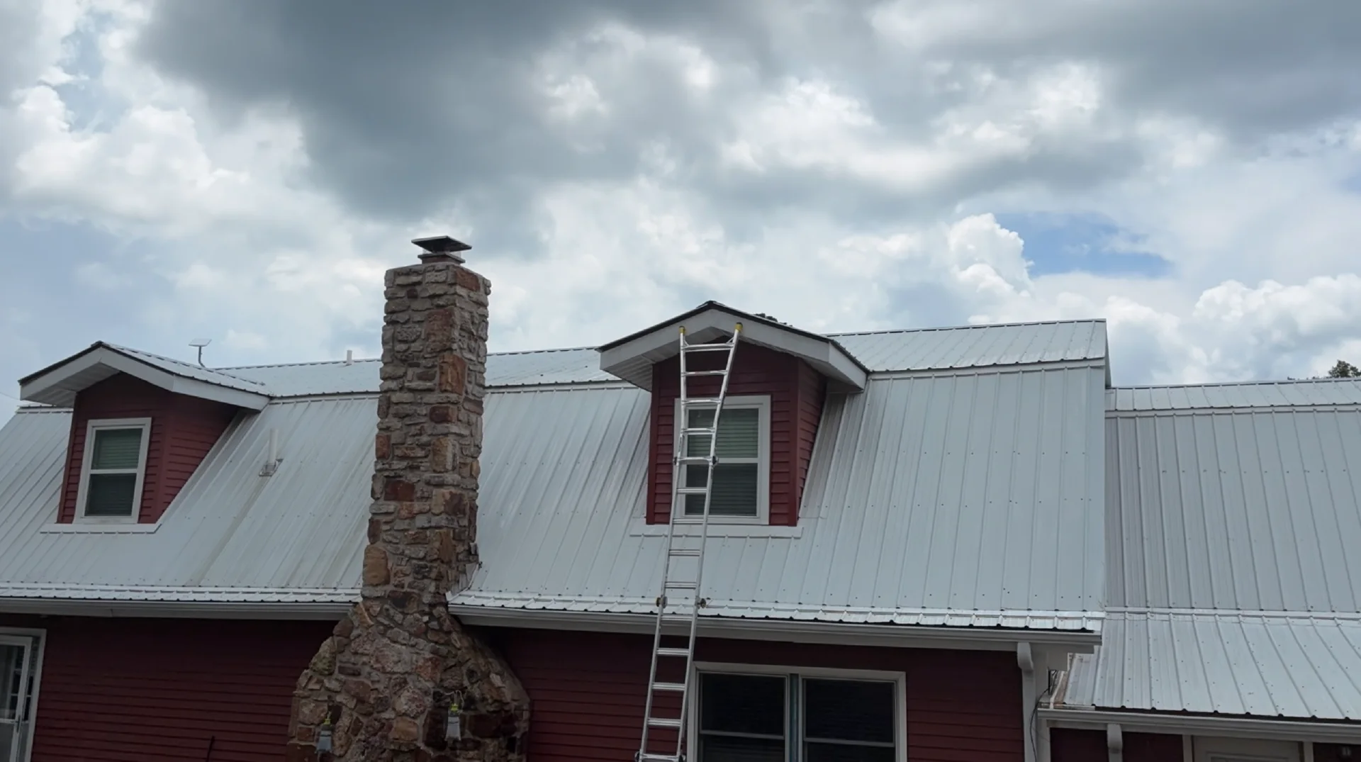 Dormers and metal roof after soft washing on a Mountain View Arkansas home