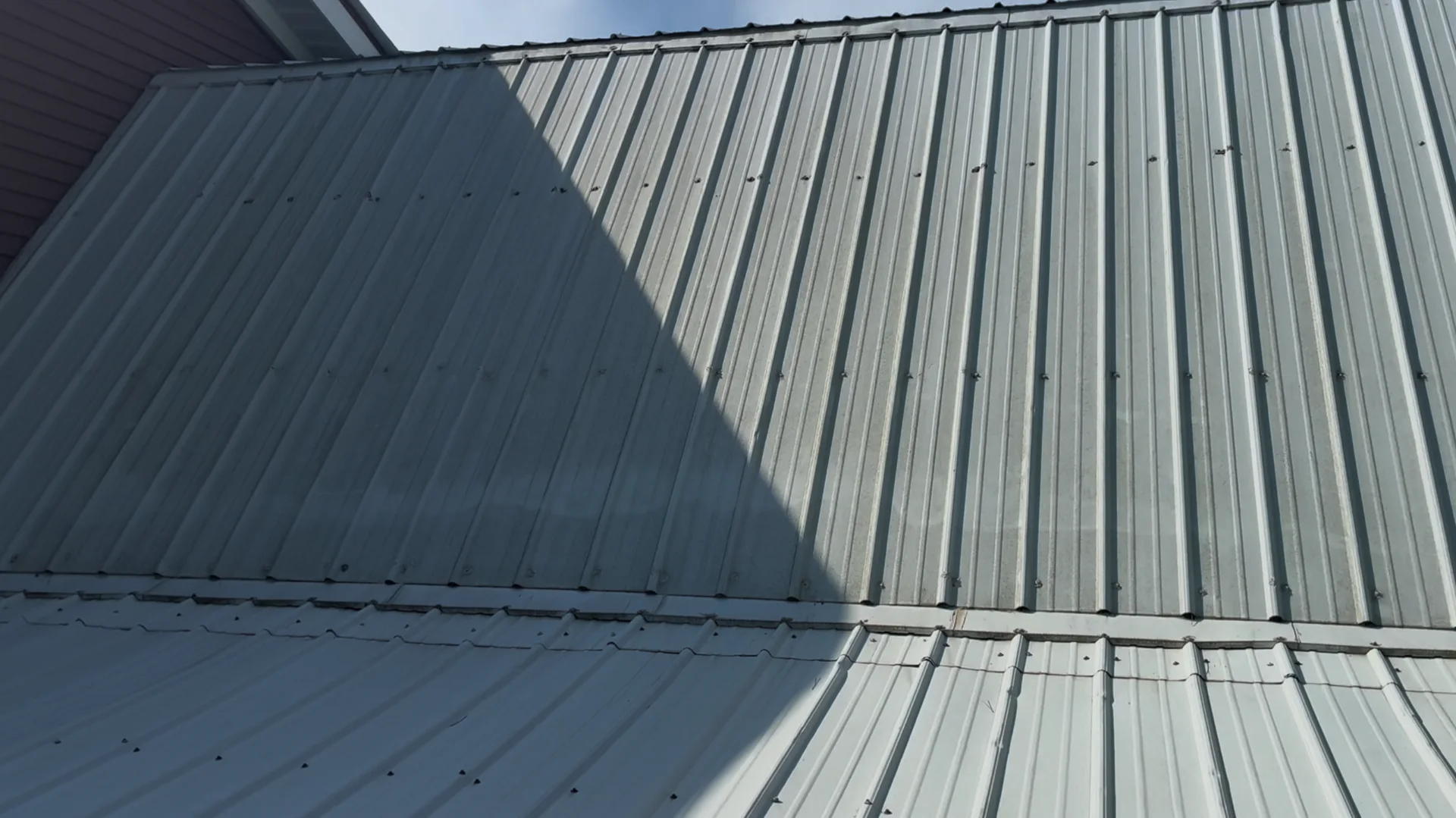 Metal roof panels in Mountain View Arkansas before soft washing, dulled and greyed