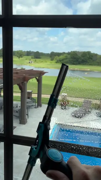Interior window washing with squeegee at a home in the Big Creek Country Club area of Mountain Home Arkansas