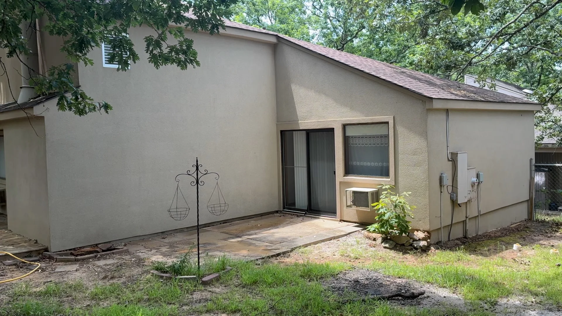 Back of a stucco home in Fairfield Bay Arkansas after soft washing, showing the cleaned patio wall