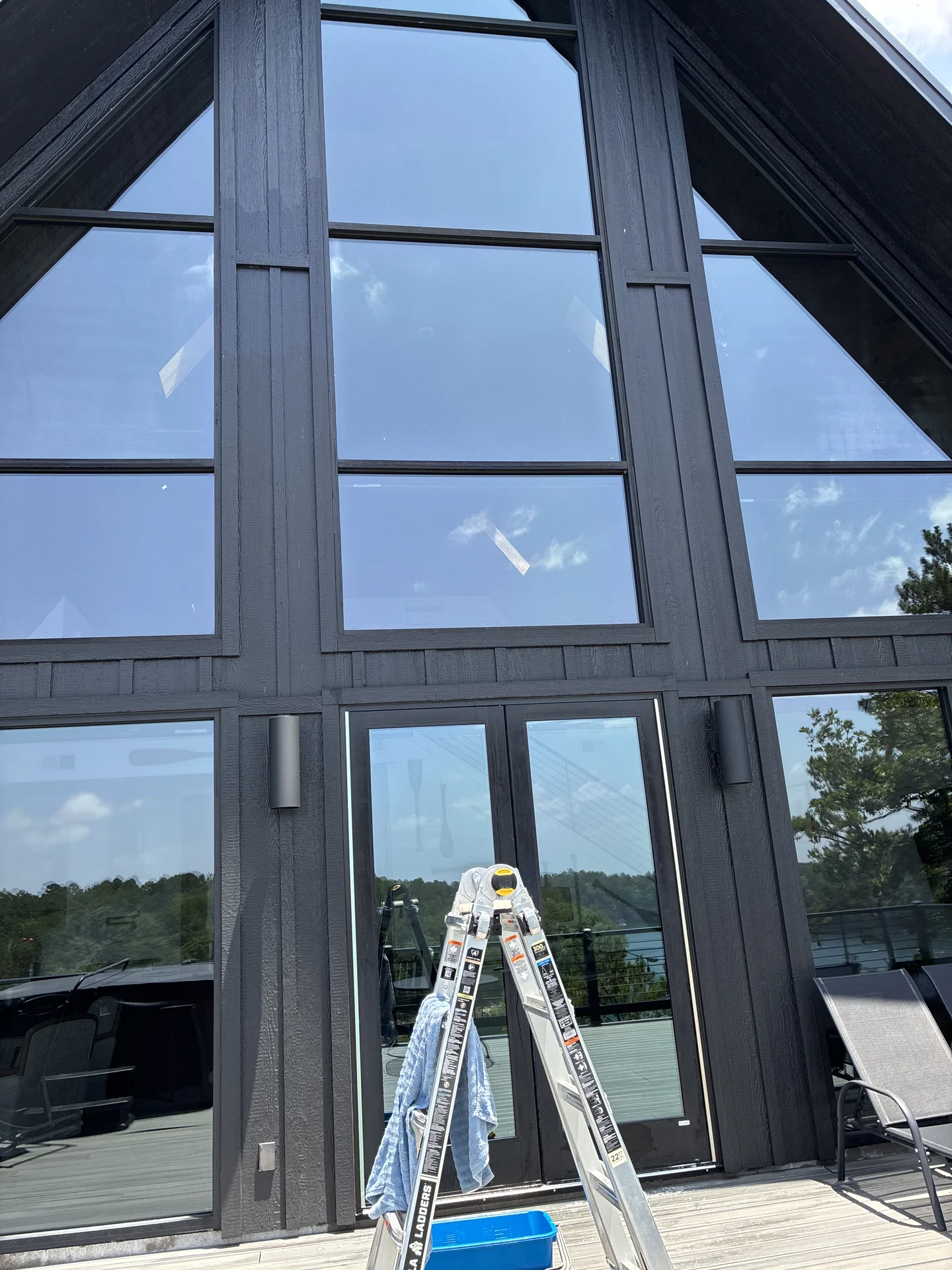 Window cleaning tools staged on the rear deck of a Drasco Arkansas lake house rental