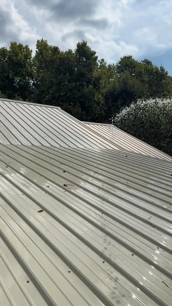 After - the same front roof section at the metal-roof soft-washing job in Allison, AR